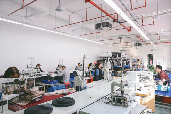 Bag makers at sewing stations in the Changrong workshop